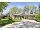 Charming brick home with a covered carport, well-manicured lawn, mature trees, and ample parking space, great curb appeal at 5431 Park Rd, Charlotte, NC 28209