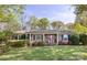 Charming brick home featuring a manicured lawn, blooming azaleas, and inviting curb appeal at 5431 Park Rd, Charlotte, NC 28209
