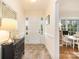 Inviting hallway featuring a stylish entry table, mirror, and a view into a bright living space with a window at 5431 Park Rd, Charlotte, NC 28209