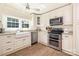 Bright kitchen featuring white cabinets, stainless steel appliances, and farmhouse sink at 5431 Park Rd, Charlotte, NC 28209