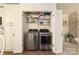 Bright laundry closet with stacked washer and dryer, white shelving, and ample storage space for linens and laundry supplies at 5431 Park Rd, Charlotte, NC 28209