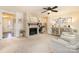 Cozy living room with stone fireplace and a ceiling fan providing comfort at 5431 Park Rd, Charlotte, NC 28209