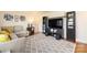 Bright living room with a decorative rug, stylish furniture, and entertainment center, perfect for relaxation and entertainment at 5431 Park Rd, Charlotte, NC 28209
