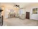 Spacious living room featuring neutral carpet, bright windows, and updated furniture at 5431 Park Rd, Charlotte, NC 28209