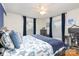 Comfortable main bedroom featuring a plush bed, natural light, and a ceiling fan, creating a relaxing atmosphere at 5431 Park Rd, Charlotte, NC 28209