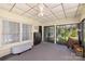 Relaxing sunroom featuring lots of windows, carpet floors, ceiling fan, and access to the backyard, great for leisure at 5431 Park Rd, Charlotte, NC 28209