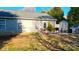 Backyard view featuring a patio area with grill, seating, and a well-maintained lawn at 8430 Stoneman Pl, Charlotte, NC 28217