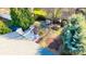 Aerial backyard view with patio, grill, unique seating areas, and mature trees at 8430 Stoneman Pl, Charlotte, NC 28217