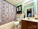 Bright bathroom with shower, sink, and medicine cabinet at 8430 Stoneman Pl, Charlotte, NC 28217