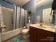 A full bathroom features a shower and tub combination, light blue paint and a tile floor at 8430 Stoneman Pl, Charlotte, NC 28217