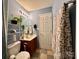 A full bathroom features a single sink, light blue paint and a tile floor at 8430 Stoneman Pl, Charlotte, NC 28217