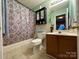 Well-maintained bathroom featuring shower with curtain, modern sink, and neutral tile at 8430 Stoneman Pl, Charlotte, NC 28217
