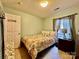 A cozy bedroom features fresh green paint, a floral-themed bed and decorative lamps at 8430 Stoneman Pl, Charlotte, NC 28217