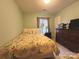 A cozy bedroom features fresh green paint, a floral-themed bed and decorative lamps at 8430 Stoneman Pl, Charlotte, NC 28217