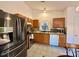 An eat-in kitchen features stainless steel appliances, tile flooring and window for natural light at 8430 Stoneman Pl, Charlotte, NC 28217