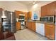 An eat-in kitchen features stainless steel appliances, tile flooring and window for natural light at 8430 Stoneman Pl, Charlotte, NC 28217