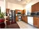 An eat-in kitchen features stainless steel appliances, tile flooring and a wooden table at 8430 Stoneman Pl, Charlotte, NC 28217