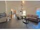 Open concept living room that flows into the kitchen and dining area, tiled floors and neutral walls at 8430 Stoneman Pl, Charlotte, NC 28217
