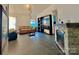 Bright living room featuring tile flooring, a decorative fireplace, and comfortable seating at 8430 Stoneman Pl, Charlotte, NC 28217