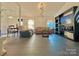 Spacious living room with large-format tile flooring, a decorative fireplace, and neutral-toned walls at 8430 Stoneman Pl, Charlotte, NC 28217