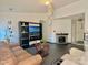 Bright living room with tile floors, fireplace, and a large entertainment center at 8430 Stoneman Pl, Charlotte, NC 28217
