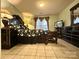 Spacious main bedroom featuring a large bed, tile floors, and plenty of natural light at 8430 Stoneman Pl, Charlotte, NC 28217