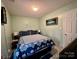 This main bedroom features a queen bed, fresh paint, tile floor and decorative butterflies at 8430 Stoneman Pl, Charlotte, NC 28217