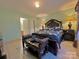 This main bedroom features a queen bed, fresh paint, tile floor and a dark wooden bed frame at 8430 Stoneman Pl, Charlotte, NC 28217