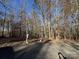 Driveway with trees and a mailbox under a clear, blue sky at 122 Breeze Hill Pl, Statesville, NC 28625