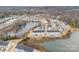 Stunning aerial view of a community with beautiful homes nestled alongside a serene lake and surrounded by lush trees at 2409 Fathom Way, Charlotte, NC 28269