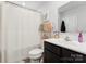 Bright bathroom features shower/tub combo with a large white shower curtain, dark vanity, and essential accessories at 2409 Fathom Way, Charlotte, NC 28269