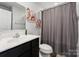 Modern bathroom featuring sleek vanity, shower with curtain and contemporary fixtures at 2409 Fathom Way, Charlotte, NC 28269