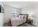 Comfortable bedroom featuring a soft grey bed frame, stylish bedding and a sun-filled window at 2409 Fathom Way, Charlotte, NC 28269
