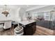 Bright dining area with modern lighting, a stylish table, and seamless access to the living room at 2409 Fathom Way, Charlotte, NC 28269