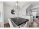 Modern dining area featuring contemporary lighting, a dark table, and light chairs at 2409 Fathom Way, Charlotte, NC 28269