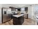 Modern kitchen with stainless steel appliances, dark cabinetry, and bright countertops at 2409 Fathom Way, Charlotte, NC 28269