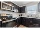 Modern kitchen featuring stainless steel appliances and dark cabinetry at 2409 Fathom Way, Charlotte, NC 28269