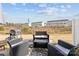 Patio with outdoor seating and a grill, perfect for entertaining, set against a backdrop of lush greenery and open space at 2409 Fathom Way, Charlotte, NC 28269