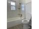 Updated bathroom with bathtub and gray tile at 31655 Pinewood Dr, New London, NC 28127