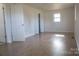 Spacious bedroom with wood-look floors and closet at 31655 Pinewood Dr, New London, NC 28127