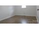 Simple bedroom with light walls and wood-look floors at 31655 Pinewood Dr, New London, NC 28127