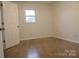 Bright bedroom with wood-look floors and a window at 31655 Pinewood Dr, New London, NC 28127