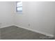 Simple bedroom with gray flooring and a window at 31655 Pinewood Dr, New London, NC 28127