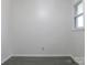 Simple bedroom with gray flooring and a window at 31655 Pinewood Dr, New London, NC 28127