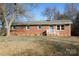 Brick ranch house with blue shutters, white steps, and landscaping at 31655 Pinewood Dr, New London, NC 28127