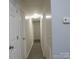 Bright hallway with gray flooring and white doors at 31655 Pinewood Dr, New London, NC 28127