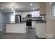 Modern kitchen with stainless steel appliances and an island at 31655 Pinewood Dr, New London, NC 28127