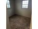 Smaller bedroom with wood paneling and two windows could be converted to a home office or study at 50 Ranlo Ave, Gastonia, NC 28054