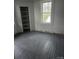 Bright bedroom with built-in shelving, light gray walls, and natural light from a window at 50 Ranlo Ave, Gastonia, NC 28054