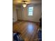 Bedroom with hardwood floors, neutral walls, ceiling fan, and natural light from a window at 50 Ranlo Ave, Gastonia, NC 28054